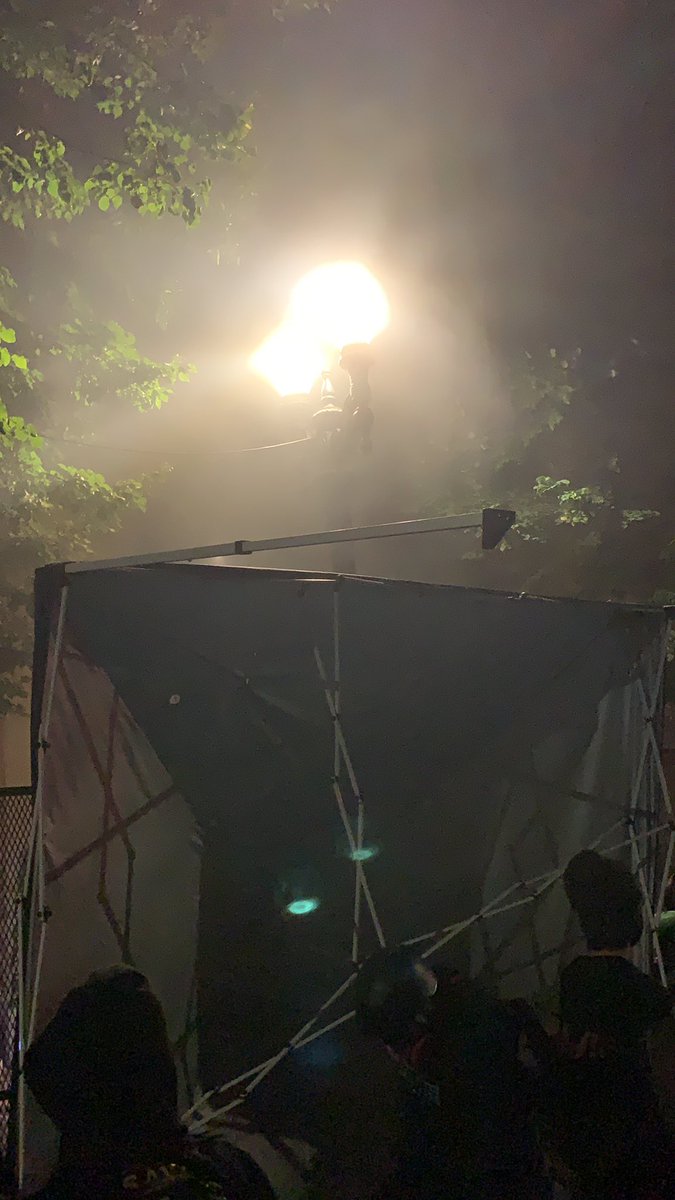 A portable canopy is now being used as a barricade in front of the fence.