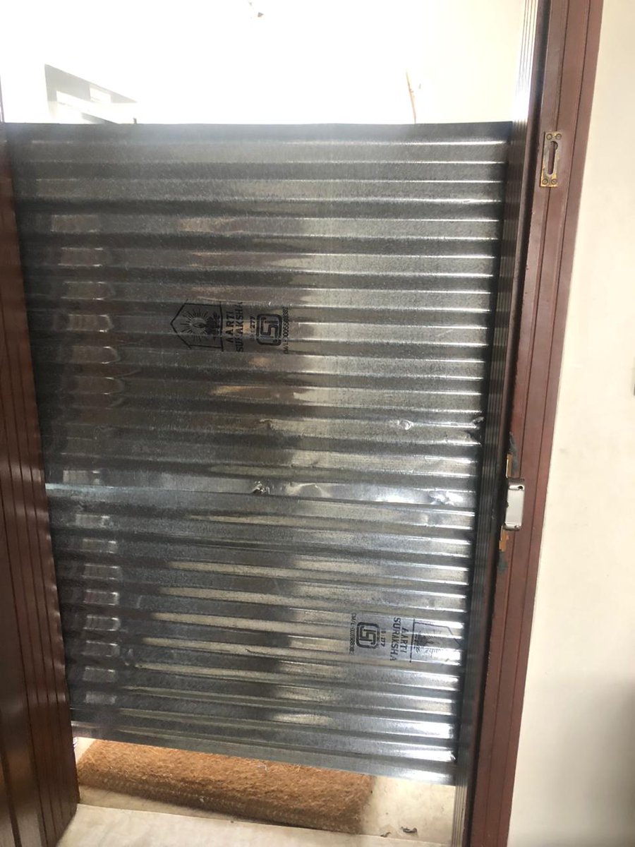satishs's tweet photo. BBMP sealing done in our building for a confirmed Covid case.  Lady with 2 small children, next door neighbours are an aged couple. What if there is a fire, @BBMPCOMM ? Understand the need for containment, but this is an extremely dangerous fire hazard - please address urgently. https://t.co/pCDMn5Pefl