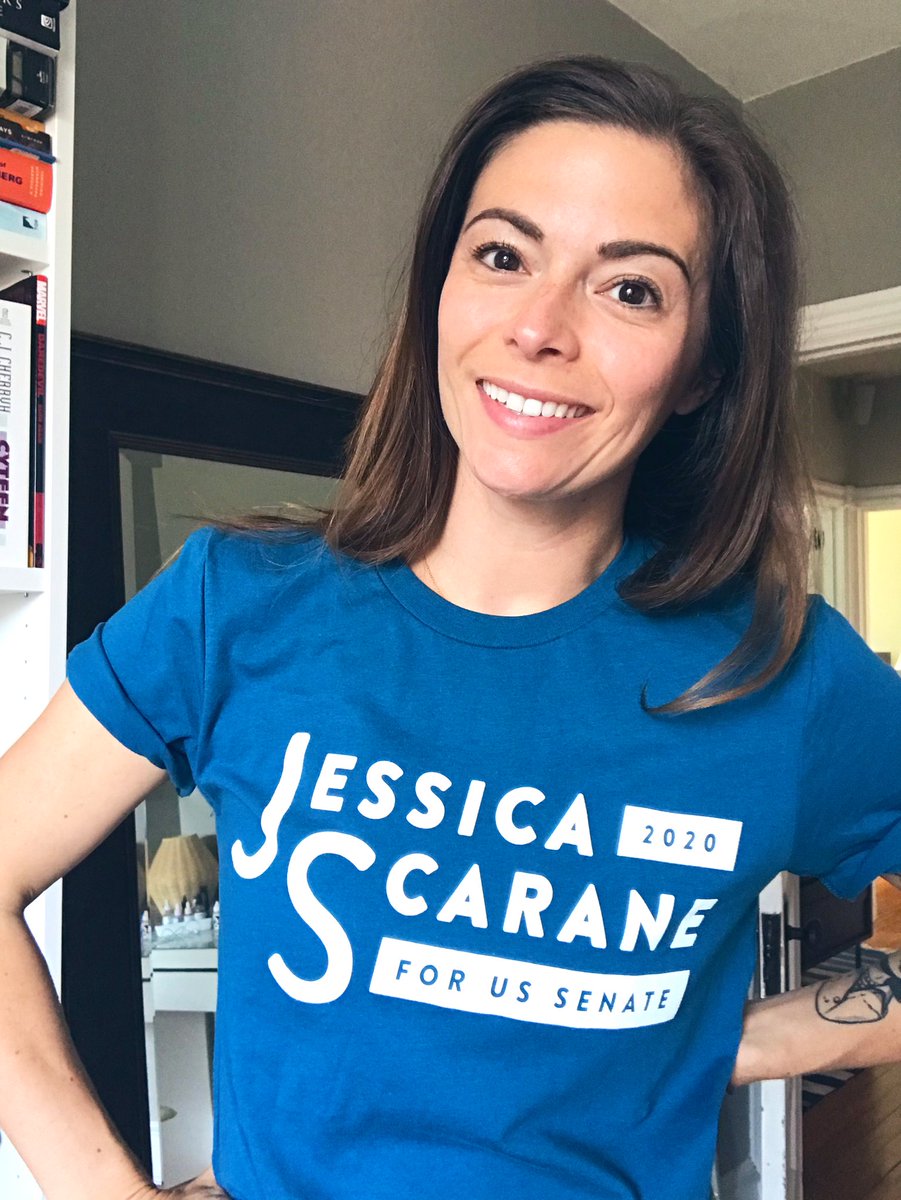 Jess wearing a teal logo tee shirt