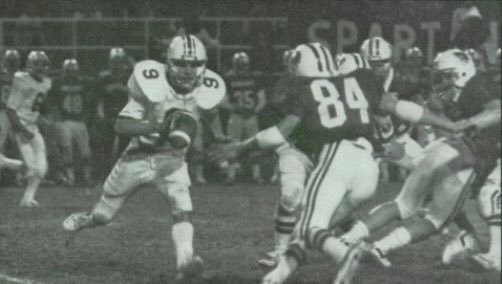 SuitUpVarsity's tweet photo. Ross Ells QBs the Rockets of Northeast v. Lincoln East in 1982. Ells led LNE all the way to state finals where they ran into the great Westside team. I know Coach Ells is LB coach for @MSU_Football, but I don’t know if he still hosts his July 4 driveway basketball tourney. https://t.co/hlLy6gIKKq