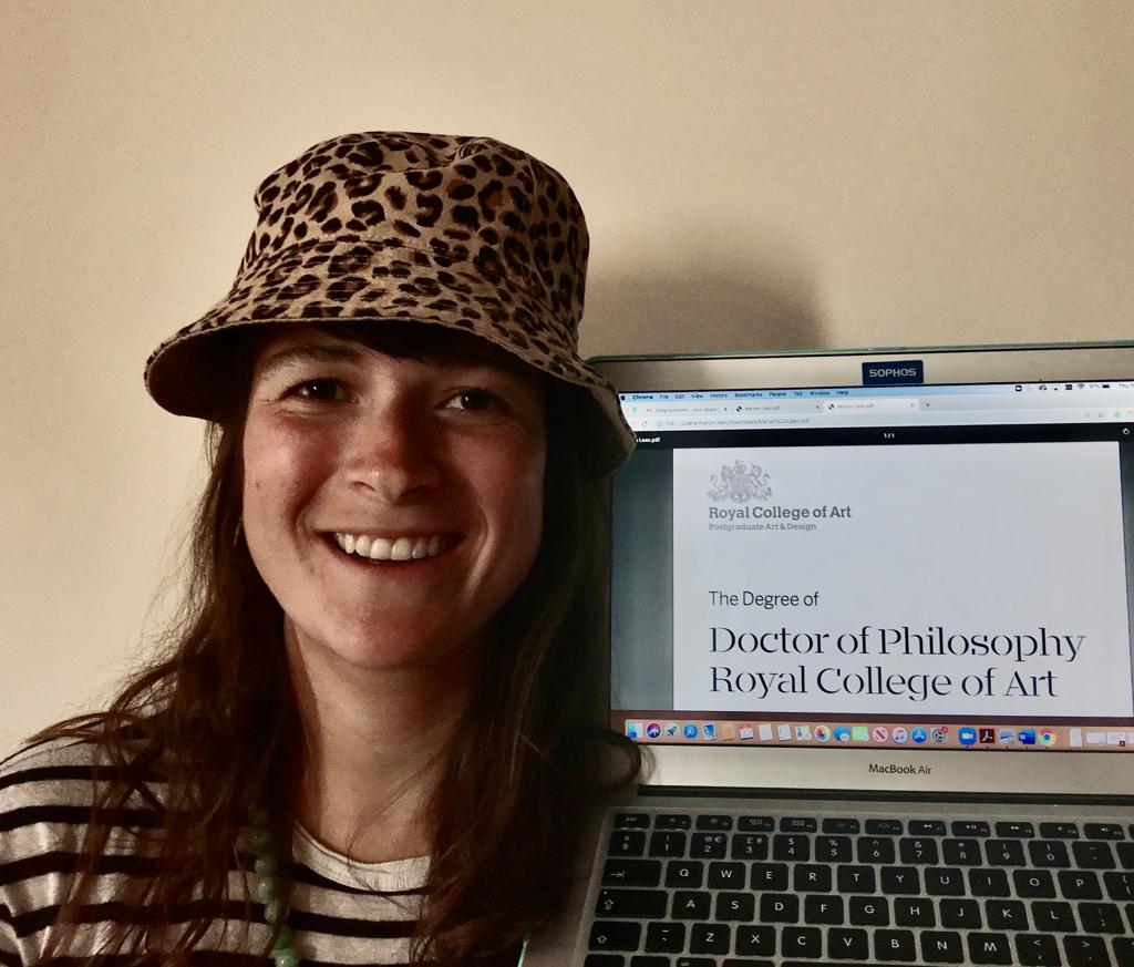 Maristotle's tweet photo. Hat: ✔️Certificate: ✔️  It's no @RoyalAlbertHall..but a fine email attachment to receive for the @RCA #graduation in my living room right now! #PhD Design Research (Textiles) | Thesis: Materialising #dataexperience through #textilethinking 👩‍🎓 https://t.co/ZQl18VYM9B