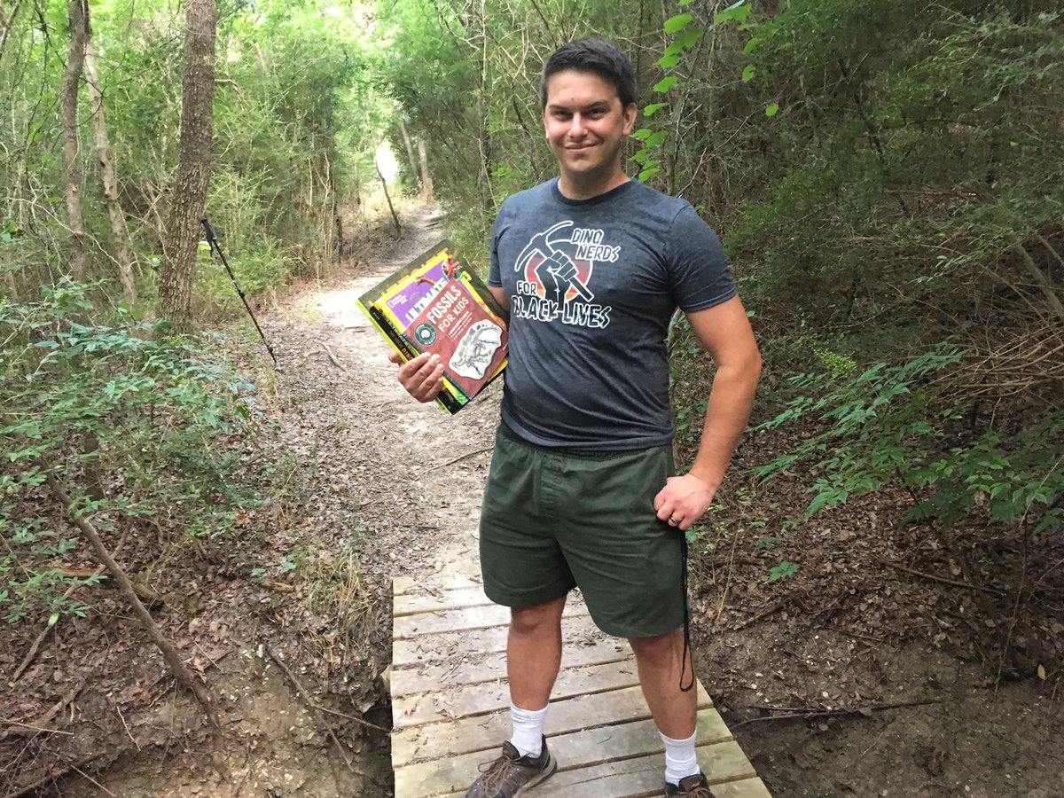 My <a href="/DinoNerdsForBLM/">Dino Nerds For Black Lives</a> shirt from <a href="/studio252mya/">252MYA</a> finally arrived! I love the design, particularly set against the dark grey (heather?) background color I chose. They might want to check their sizes though; while labeled as a large, it seems more like a medium. #BlackLivesMatter