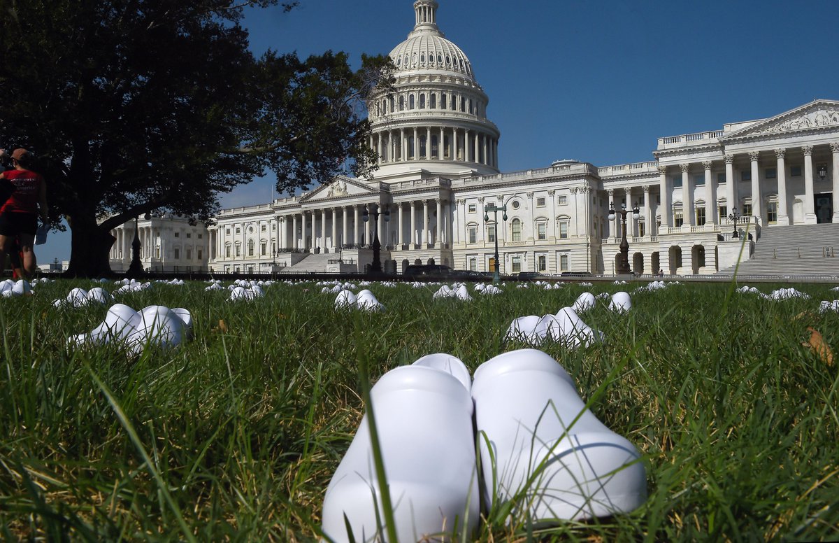 enews's tweet photo. 164 pairs of nurses' shoes were placed on the lawn of the U.S. Capitol to represent nurses who have died in the fight against COVID-19.⁣📍Washington, DC. https://t.co/DY5NSs8xVu