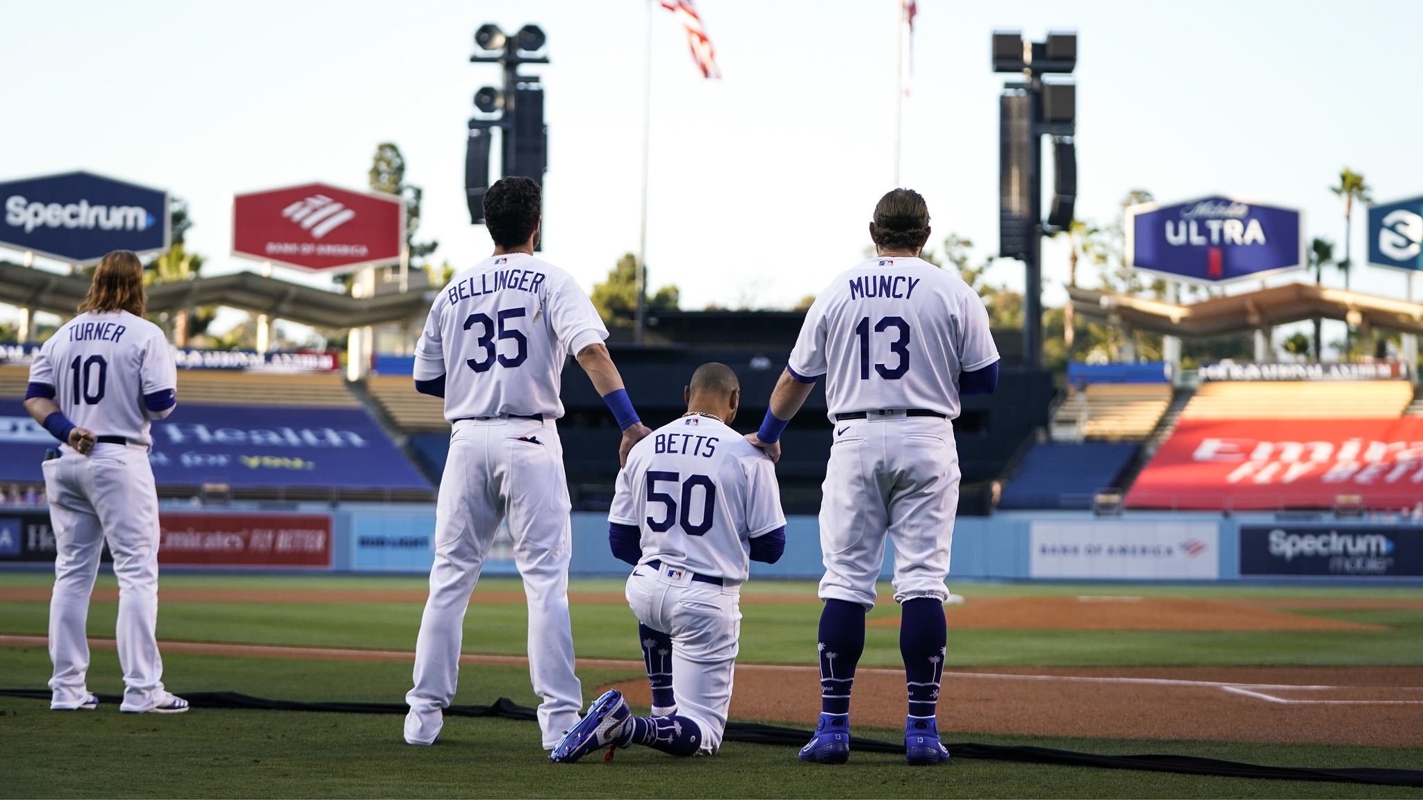 MLB on X: Mookie Betts takes a knee during the National Anthem, supported  by teammates Cody Bellinger and Max Muncy.  / X