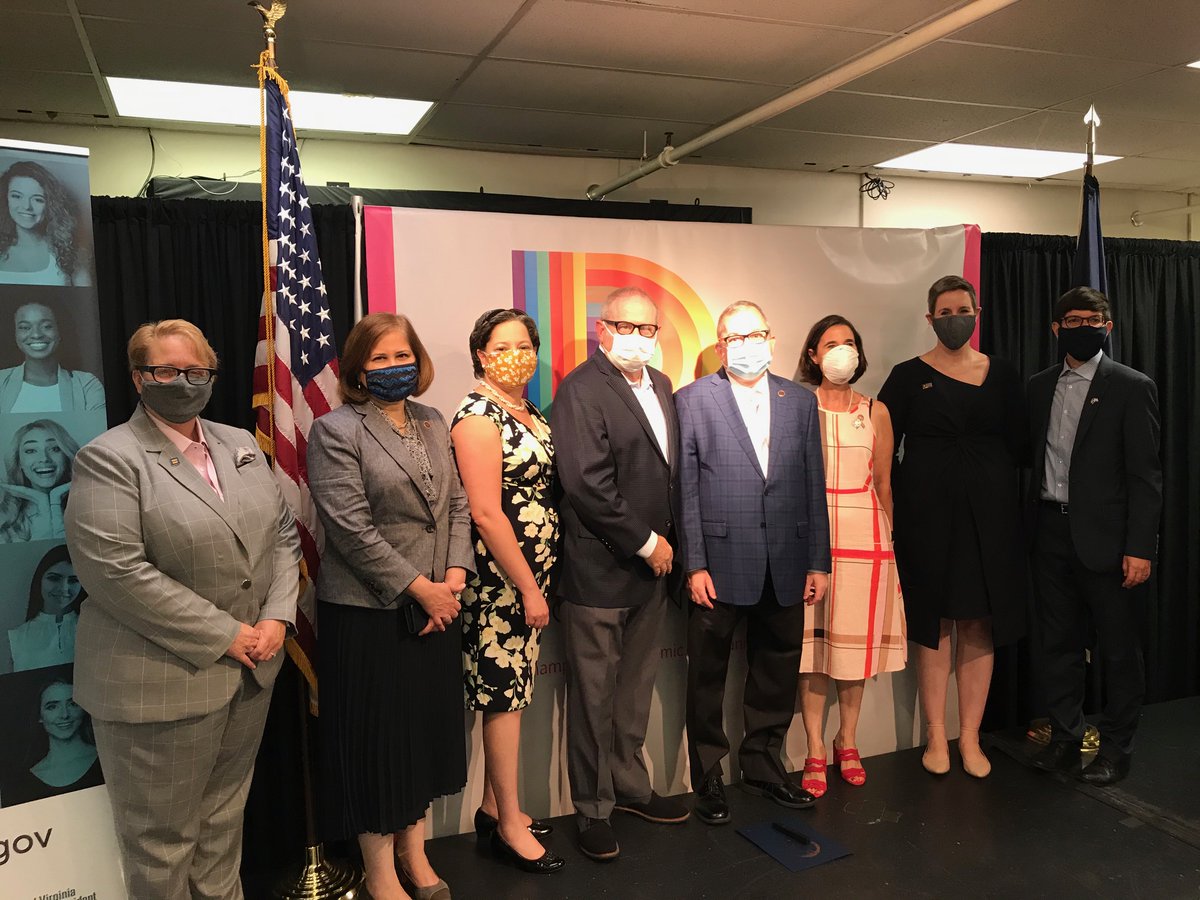 Everyone standing together, wearing masks