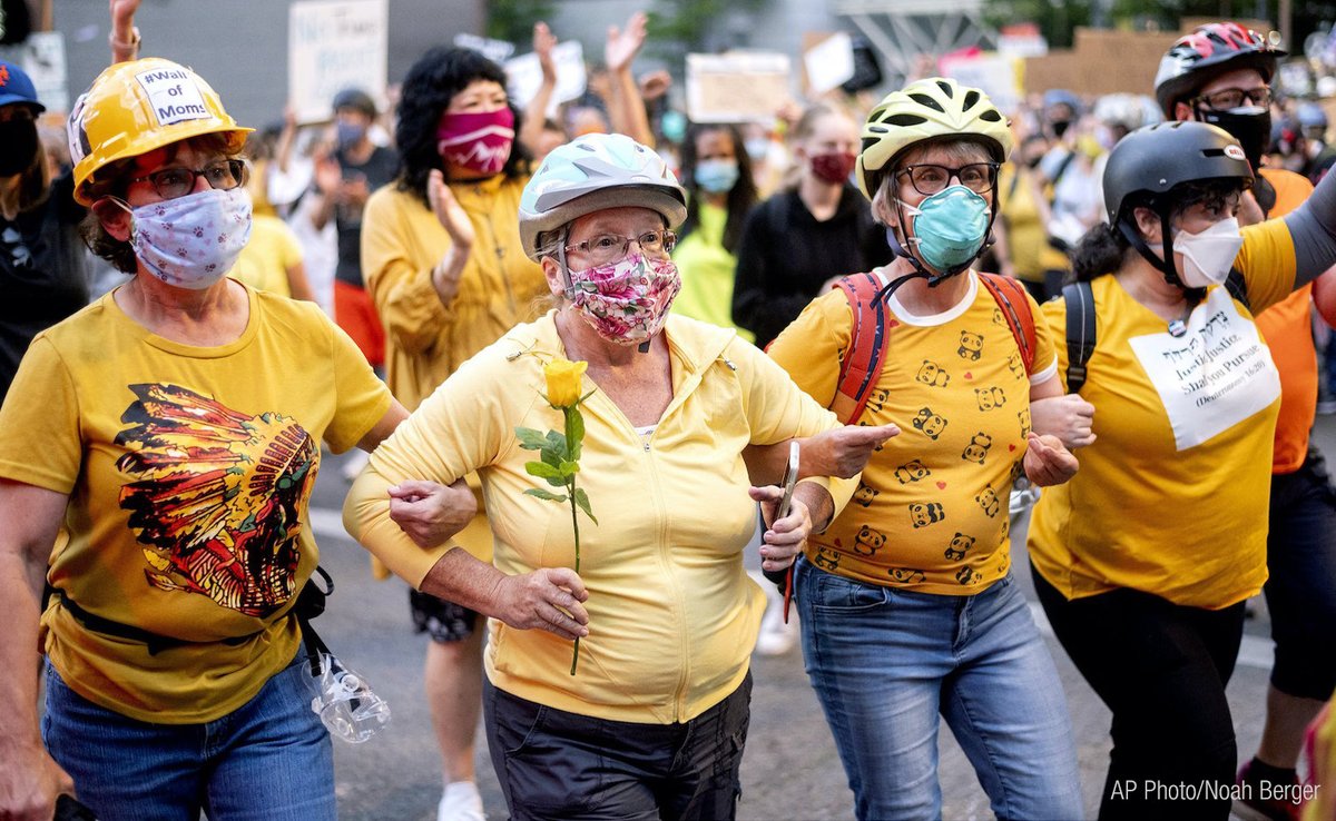 MAContinents's tweet photo. Never underestimate the power of women. In Portland, OR, a ‘Wall of Moms’ stepped up to form a protective barrier between BLM demonstrators and federal officers. One protester commented, “Moms protect their families, but we need to remember that the entire world is our family.” https://t.co/Q9WXNZ9a0Z