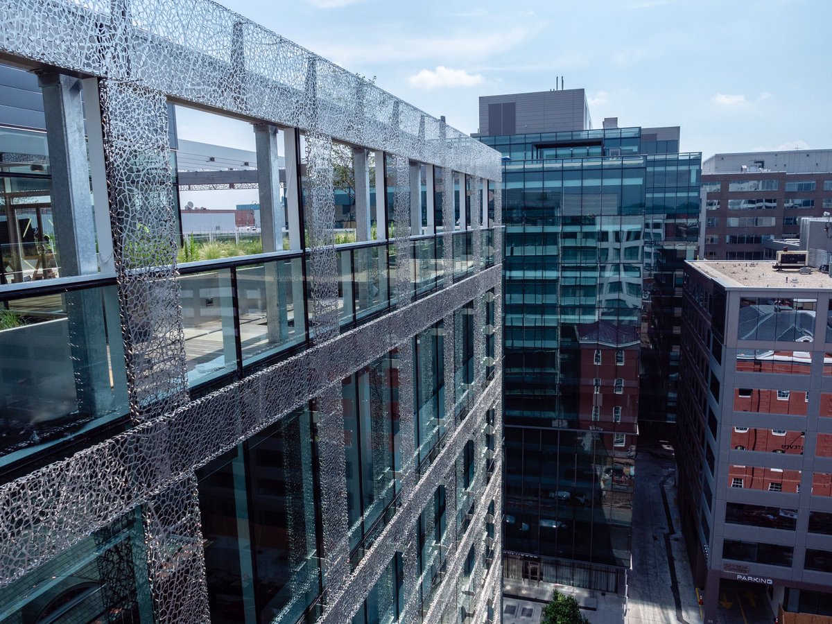 DAVISbuilds's tweet photo. The steel exterior veil at 2100 L St is designed to resemble the willow oak tree, and adds a reflective embellishment to the glass exterior. Our project team reached substantial completion at the end of April—congratulations to our team and amazing partners! #DAVISinMotion https://t.co/Hya7CNysmx