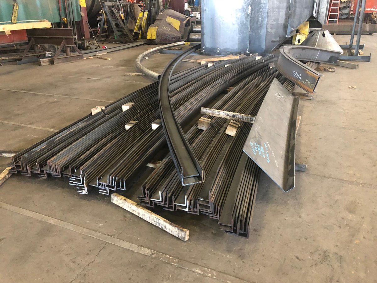 Longero_Inc's tweet photo. A nice mix of rolled items including rolled beams with straight tangents (probably for a trolley) , a bent and then rolled plate (rolled leg in), rolled L3"x3"x.375" (95 each), rolled leg in and leg out L4"x3"x.25", and lastly a rolled 4" stainless steel pipe. https://t.co/630kCTUajI