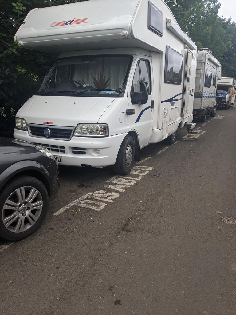 glastogeoff's tweet photo. Where is @MendipCouncil traffic wardens? Bottom of Tor is full of camper vans in disabled spaces. Why aren't they getting daily fines https://t.co/y1xNJyJPcE