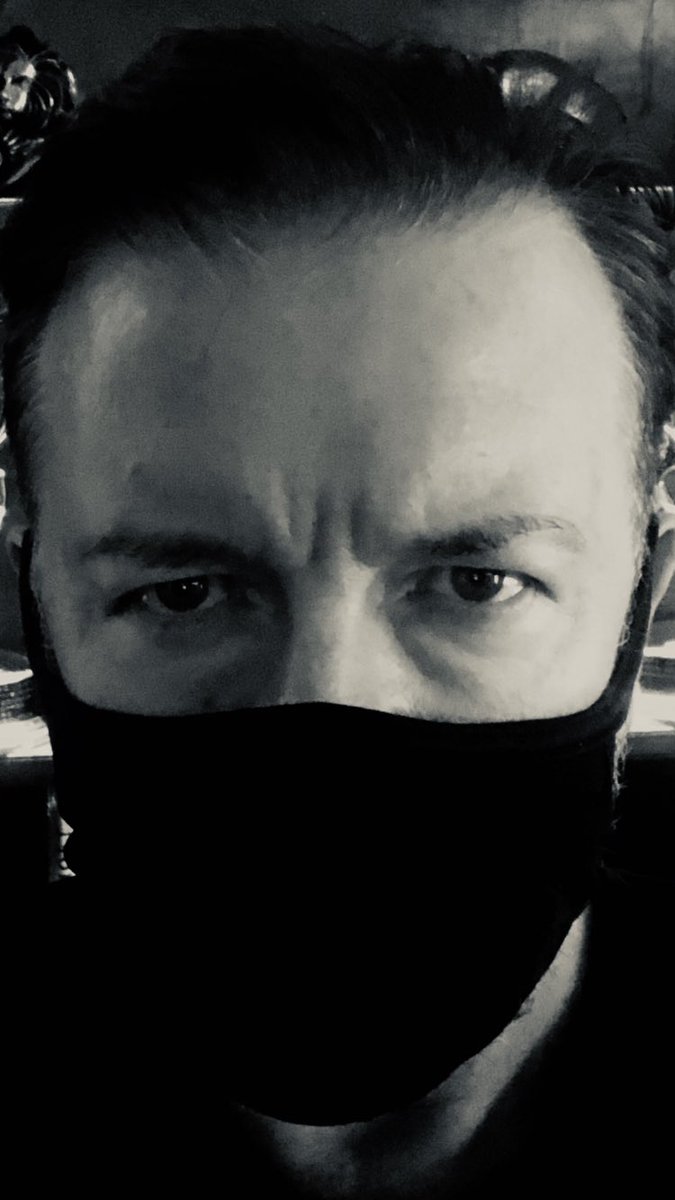 rickygervais's tweet photo. There’s good news and bad news. The bad news is there’s a global pandemic. The good news is I look great in a mask. So, every cloud. You’re still thinking of the bad news, aren’t you? https://t.co/mPfjnVjawX