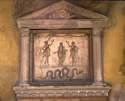 "In the Mediterranean world a snake living in the house embodies the soul of family’s first ancestor; for the Romans the serpent embodied the paterfamilias. Murals at Pompeii show vipers protectively surrounding an altar as symbols of the genius loci, tutelar deity of the place."