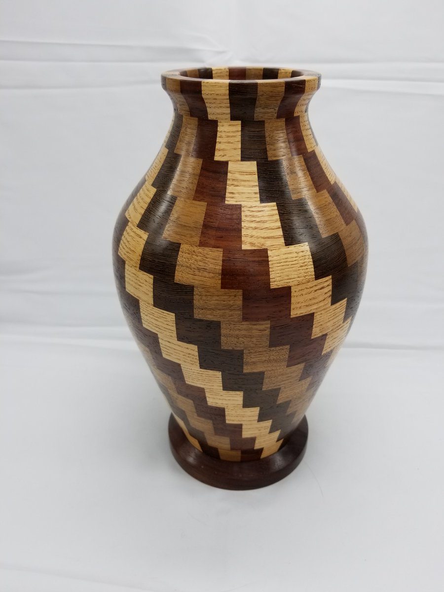 The first segmented vase I attempted in 2018. Padauk, walnut, white ash, Wenge. #woodturning #woodworking #wooddesign #handmade #woodshop #garagewoodshop #woodworker #woodworkersofinstagram #woodenart #woodworkcraft