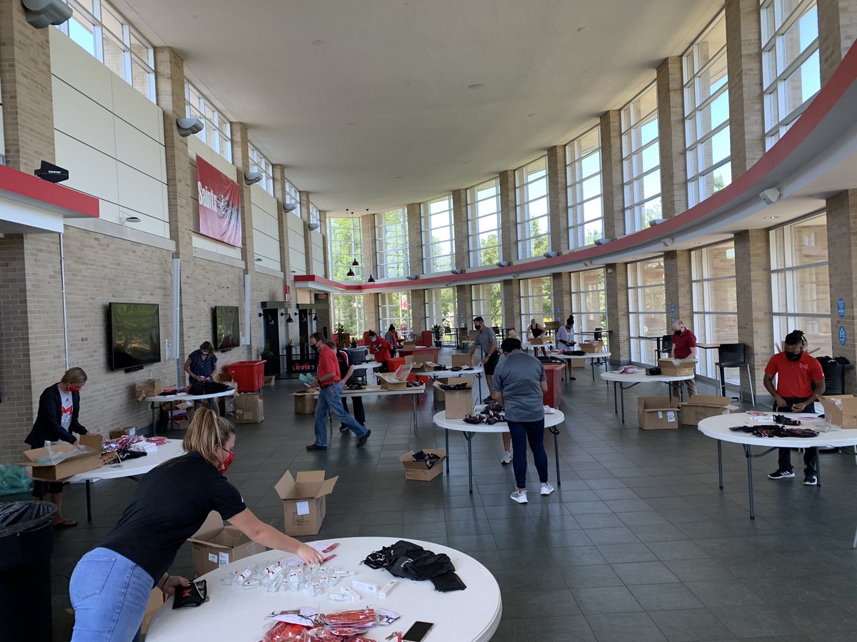 Making student care kits - Maryville masks, thermometer, and hand sanitizer #SaintStrong