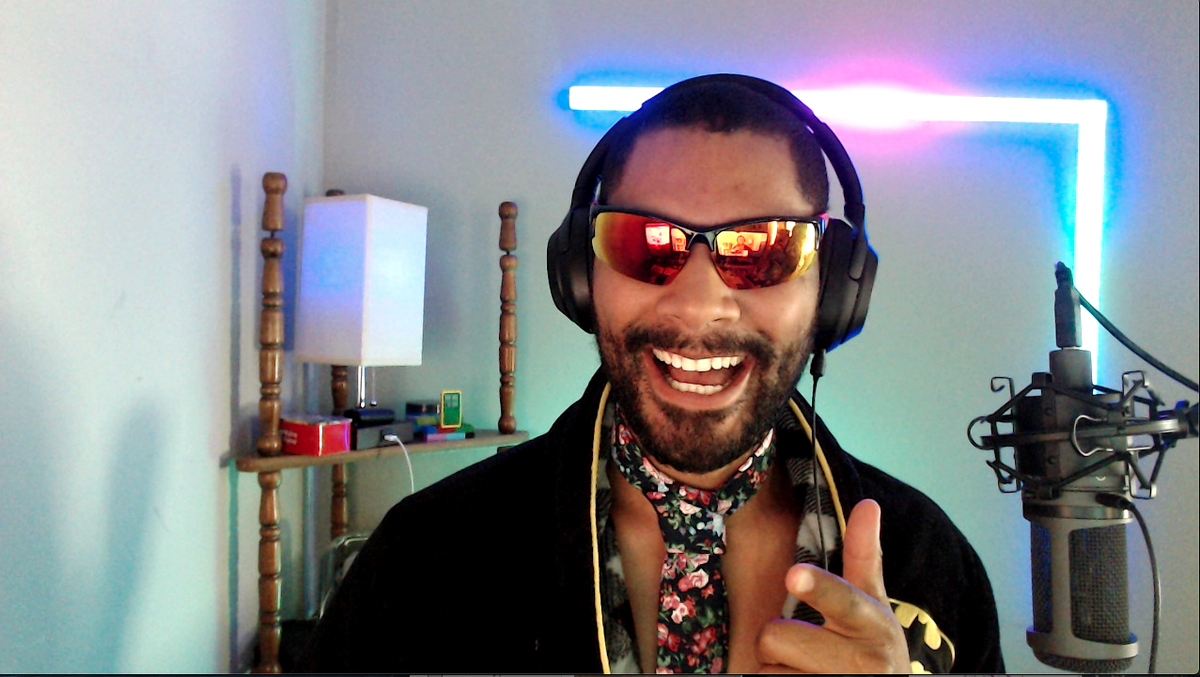 me wearing a batman robe, sunglasses and a floral tie.