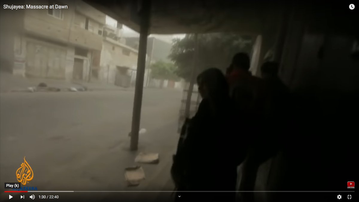 Look at the area above the woman's head.You can see dust pouring down from the mortar detonation.You can also hear debris hitting the metal awnings.