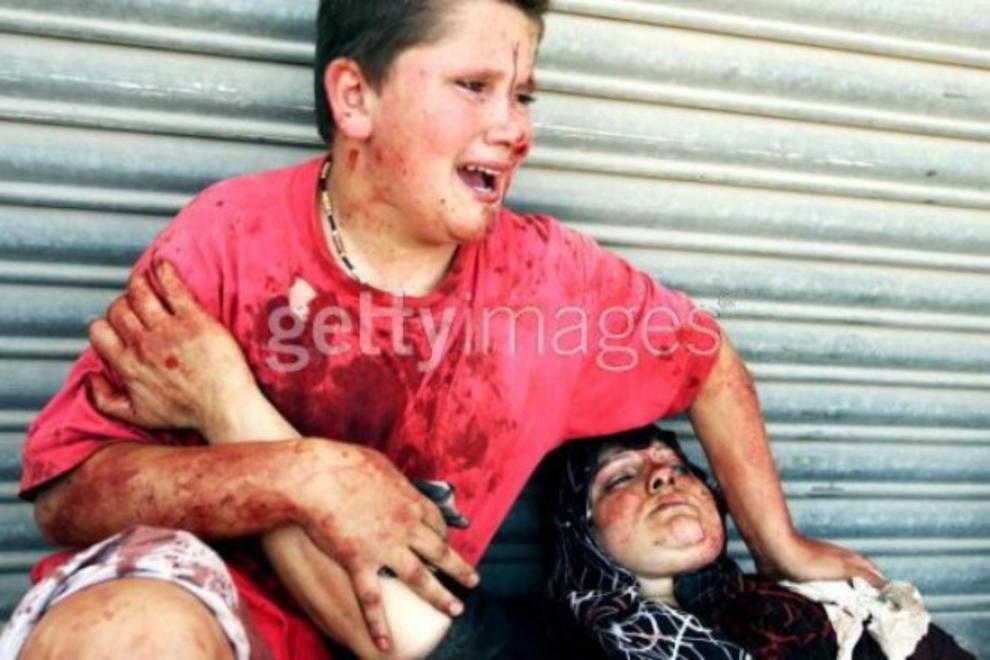 Lebanon, during the 2006 Hezbollah-Israel war.Look at each image. I have a surprise for you, so it's okay to look.A boy cries over his dying mother.