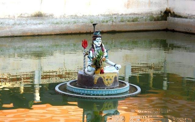 ॐ नमः शिवायShiv Dham is dedicated to Lord Shiva and is famous for its architecture.This temple actually situated in the middle of a Water Kund! The temple looks amazing during sunset when the orange rays of the sun fall on it and highlight the carvings and design of the temple.