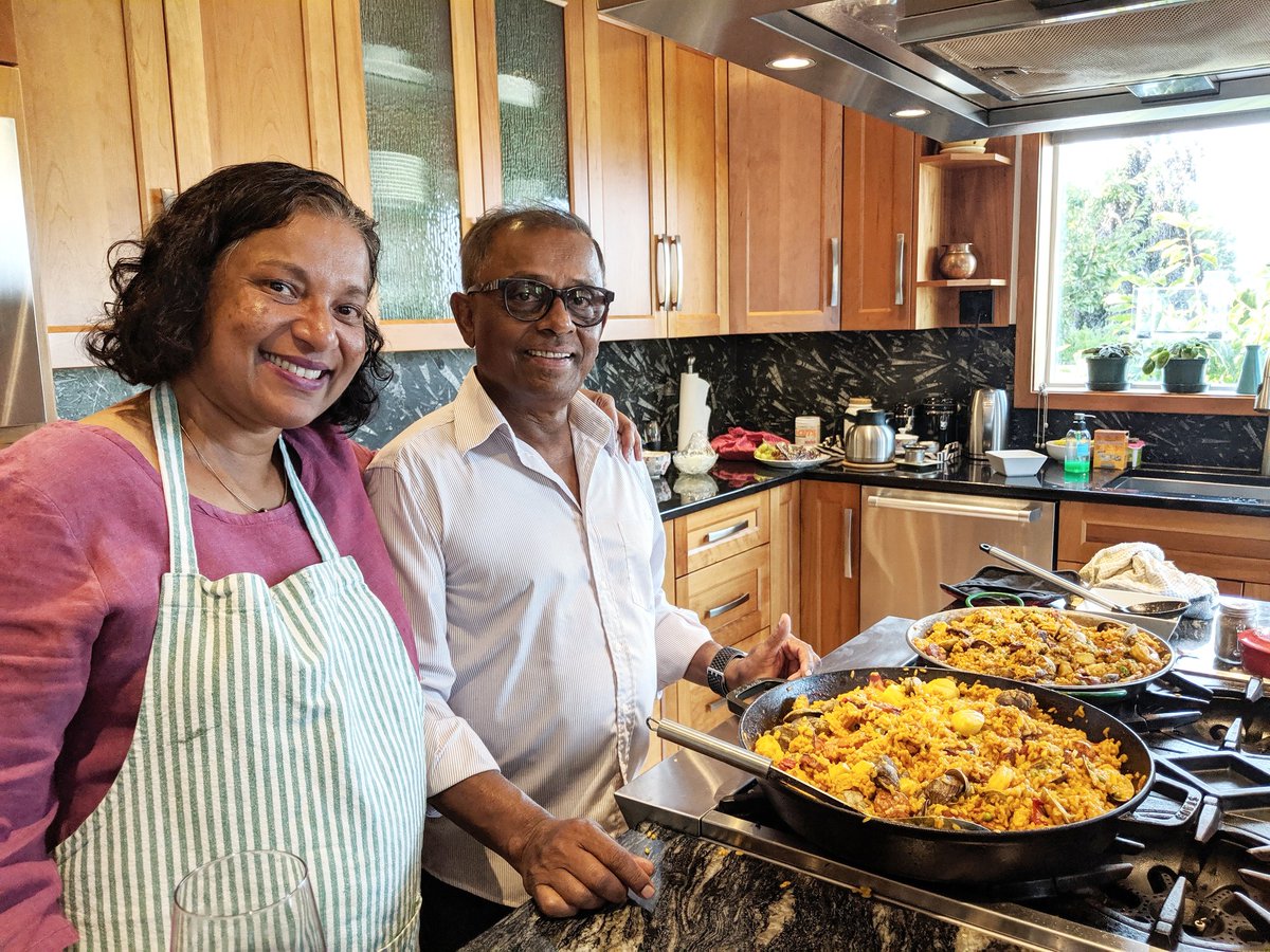 I reread the thread this morning and noticed a few writing errors. I wrote it moments after seeing the picture, so I was a little overcome with emotion. With candor and spontaneity comes error? Anyhow, here's a picture of my lovely parents with a giant pan of paella. I love them.