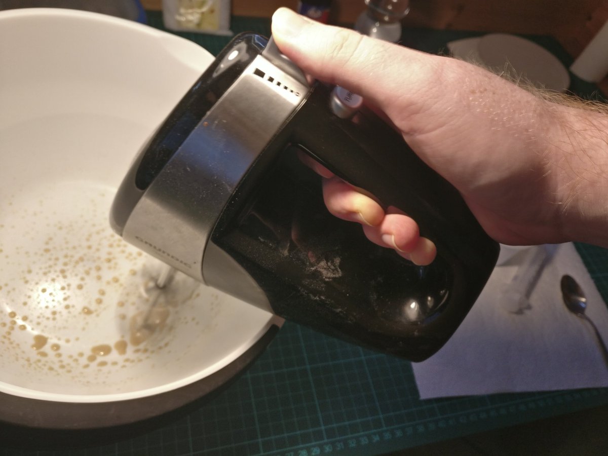 Combine 2 g of gum arabic, 4 ml water, and our oil mixture with a hand mixer. Keep mixing until it emulsifies, it will take on a milky brown color and the oily phase will disappear. This took me about 5 minutes.