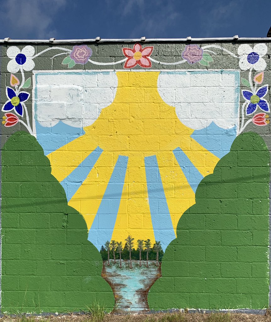 emmaline_austin's tweet photo. I finally got to walk across the stage and close out my undergraduate career! My honors college project at #UNCP was to paint a mural which I titled #BeTheLight, so it was only fitting to stop and take some grad pics in front of it! 
This moment was surreal. https://t.co/USmCA2Og6V