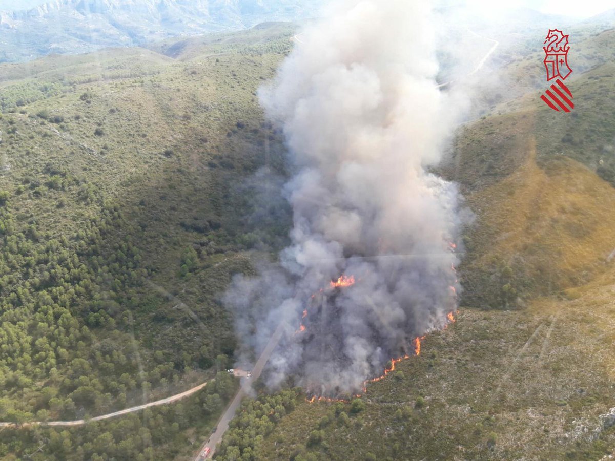 radiogandia's tweet photo. 🔴 Incendio forestal en la Vall de Gallinera, concretamente entre la Llacuna de Villalonga y l'Orxa. Una gran columna de humo se aprecia desde la comarca de la Safor. 10 medios aéreos trabajan para extinguir el incendio. #IFValldeGallinera https://t.co/C6cCfeeY2U