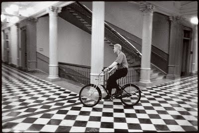 Next up: Bill Clinton. There's several pictures of Clinton on a bike. Here's one of him riding a bike indoors.
