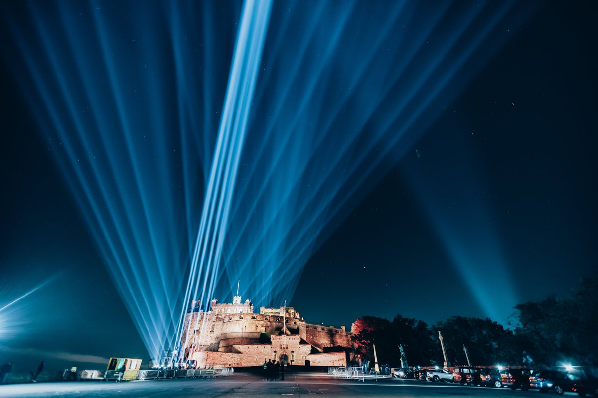 Beams of blue light shine into the sky from Edinburgh Castle.