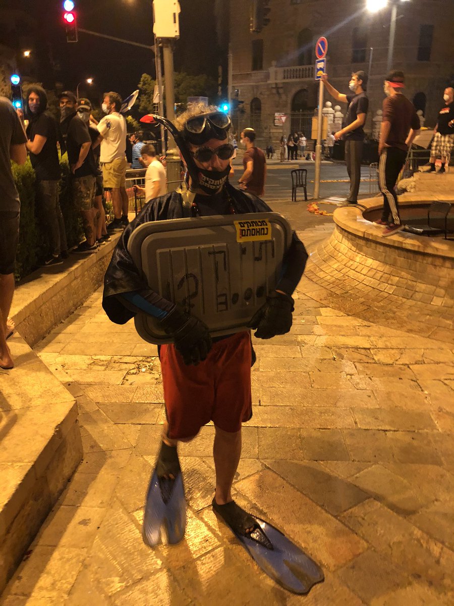 A protestor in diving gear calling for an investigation into the “submarine affair”, one of the corruption cases against Bibi which was dropped and not included in his indictment
