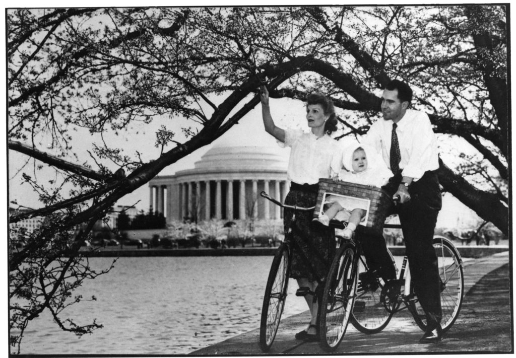 Next up is Richard Nixon. Here is with his wife Pat and their baby daughter biking to see the cherry blossoms.