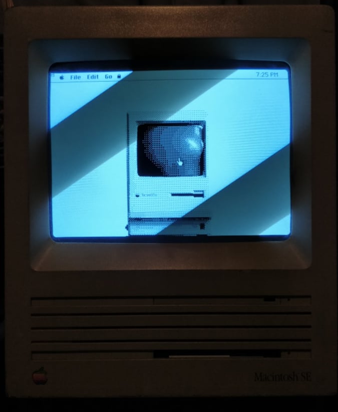 a stippled image of an old macintosh computer in the monitor of an old macintosh computer