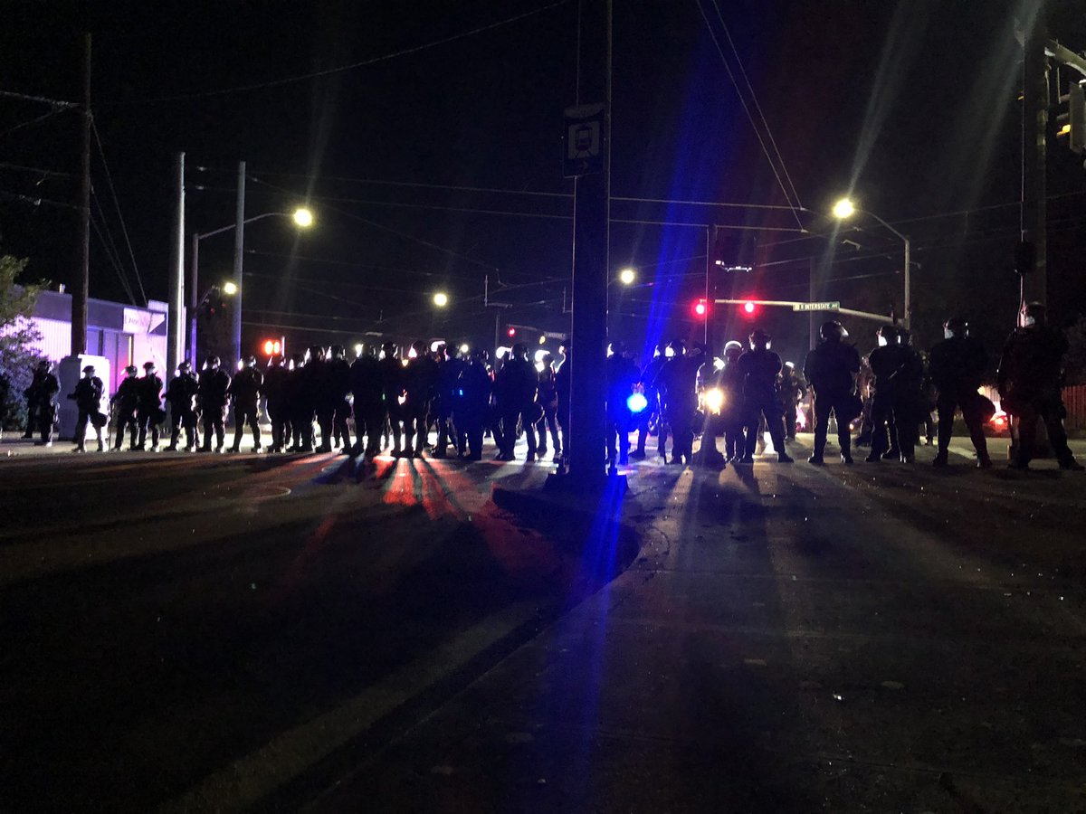 Corner of Interstate Ave, protestors asking PPB, “what do you want us to do?” PPB responds by telling them to “go home.” Another protestors shouts at PPB that this is, in fact, her neighborhood.  #PortlandProtests  #PDXprotests