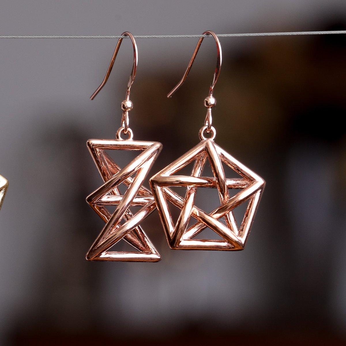 Forbidden Subgraph earrings are inspired by Kuratowski's theorem: that it is *impossible* to draw a graph on paper without edges crossing if your graph contains K33 or K5 (left/right). Brass and Bronze versions in stock now at hdsn.us/ME230. #mathjewelry #graphtheory