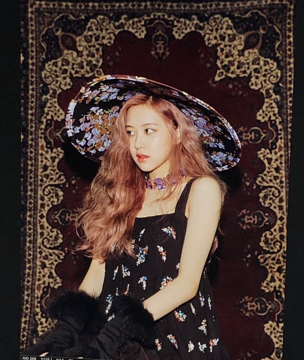  Her red hair is curly and her makeup is glittery, shining like the stars around her