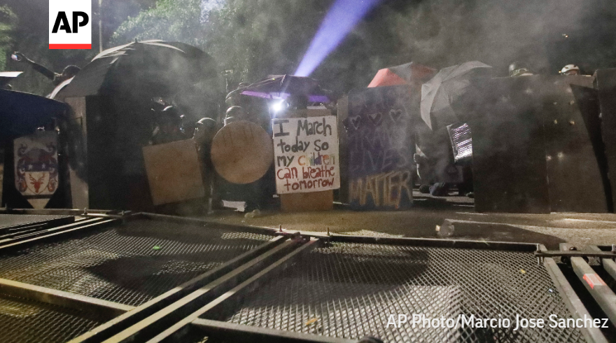 Agents used tear gas to push back the people assailing the fence and throwing fireworks at agents, but smoke also seeped deep into a park across from the courthouse.  http://apne.ws/hbE0ATw 