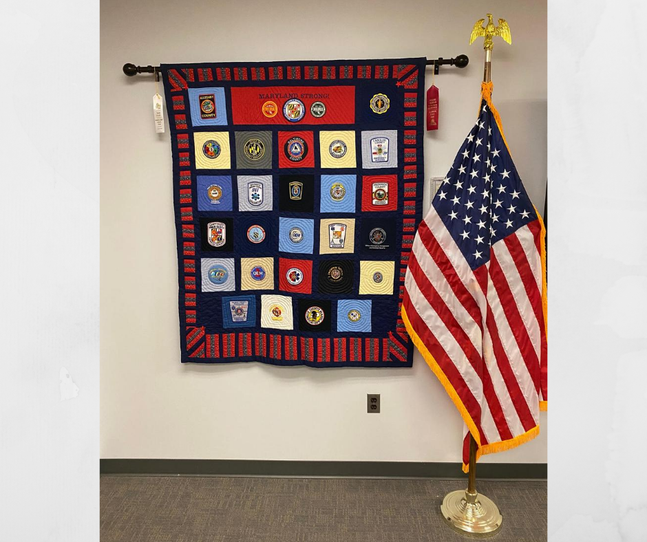 MDMEMA's tweet photo. Cindy decided to make another quilt the following year &amp; presented it to MEMA's Exec. Director, Russ Strickland, at the '17 @MarylandEMA Symposium. The quilt is hanging in the State Emergency Operations Center. On behalf of #TeamMEMA, thank you Cindy for your thoughtful gesture! https://t.co/B1VnfFUgFz