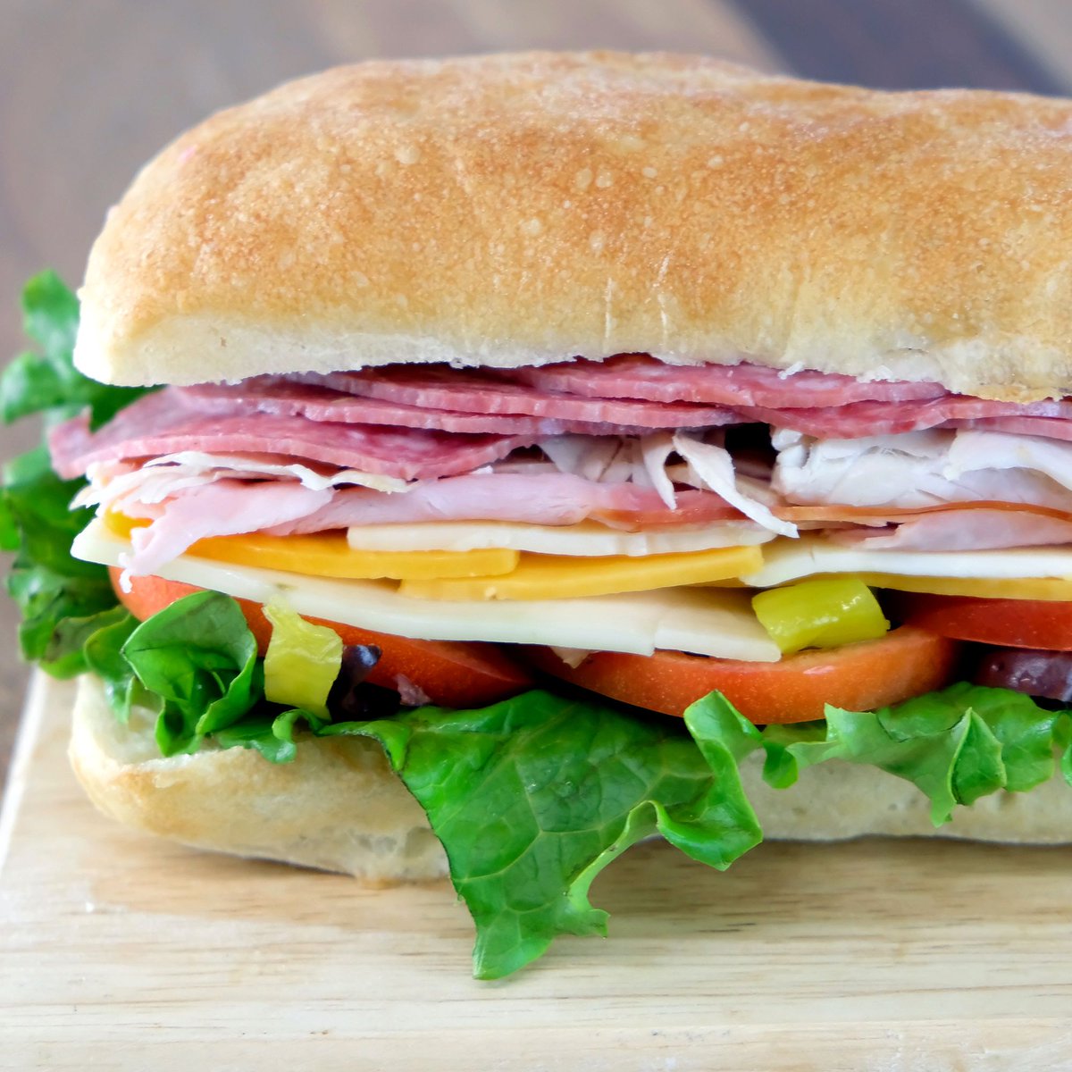 We’ve practically doubled the meat and cheese on this gigantic sub! Now comes with Italian Salami, Roast Turkey, Ham, Pepperjack cheese, Cheddar cheese, sliced kalamata olives, sliced pepperoncini and tomato. Served on a fresh baguette.
