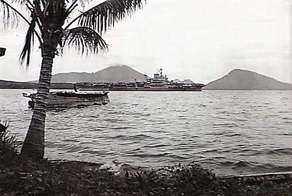 6/6: The long-awaited day arrived; Oct 30,1945. The a/c carrier HMS Formidable left Rabaul packed with over 1,000 soldiers returning home to Singapore and India. Many RN ships involved in repatriating troops. Directly behind ship is the volcano. in front: sunken enemy warship.END