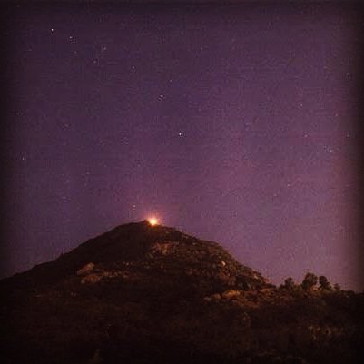 Vishnu after realizing there's no end to the fire column accepts defeat & bows to Shiva. This fire column is said to be represented by the Arunachala Hills, next to Arunachaleswara Temple. Legend declares the hill as a holy place, as it represents the primordial form of Shiva.