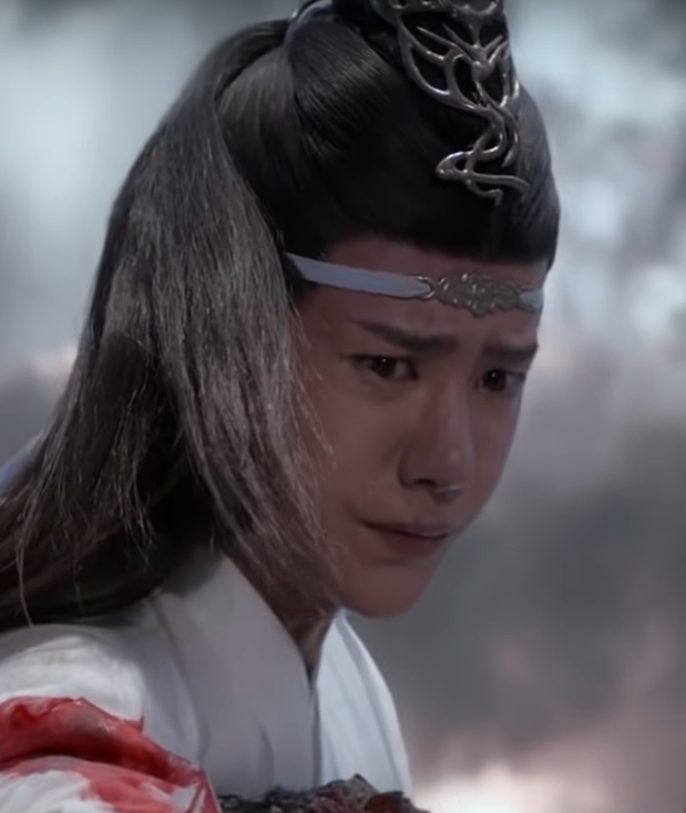 Lan Zhan is holding him, but he clearly doesn't have the strength to pull him up. He nearly drops him.