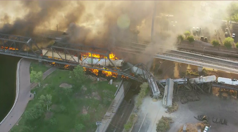 GinaMaravillaTV's tweet photo. #BREAKING First images from @chopperguyhd of the bridge collapse and train fire on the north end of downtown Tempe, east side of Tempe Beach Park. #azfamily https://t.co/Xr1Q6CWrQC