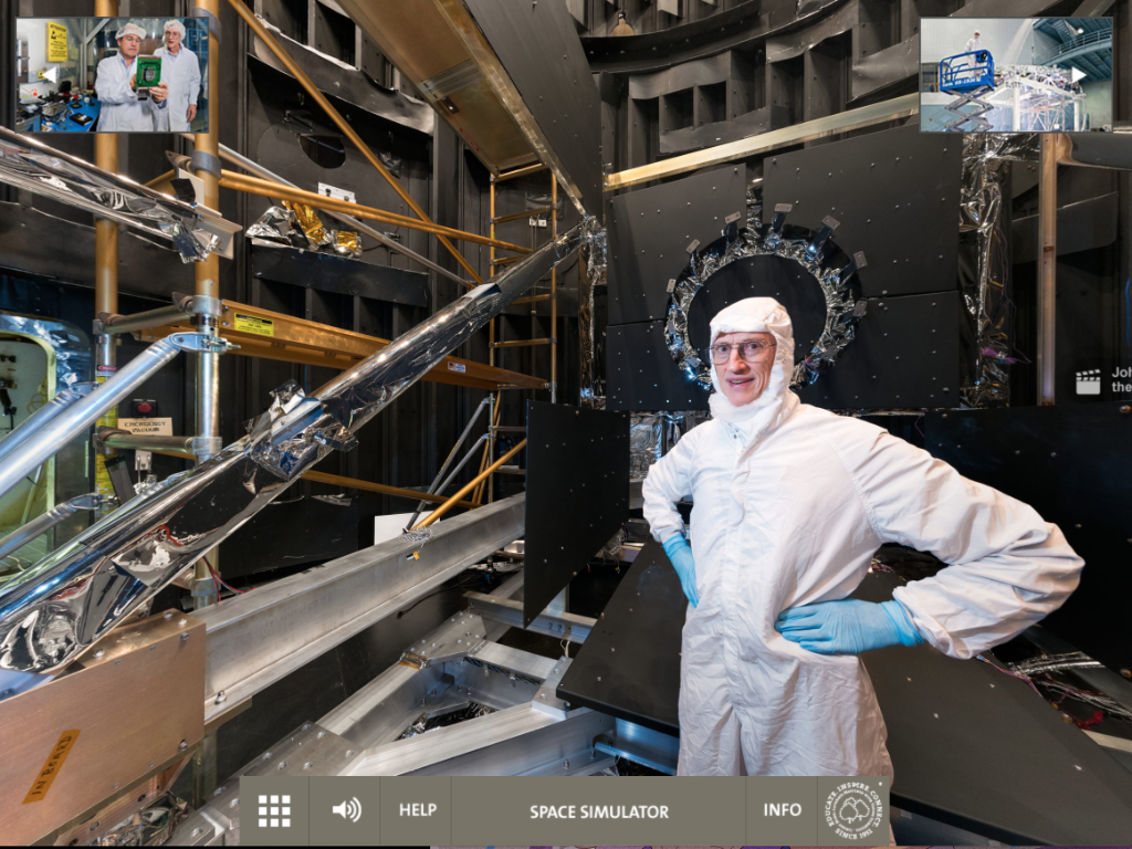 Dr. John Mather in a cleanroom suit standing in a lab. 