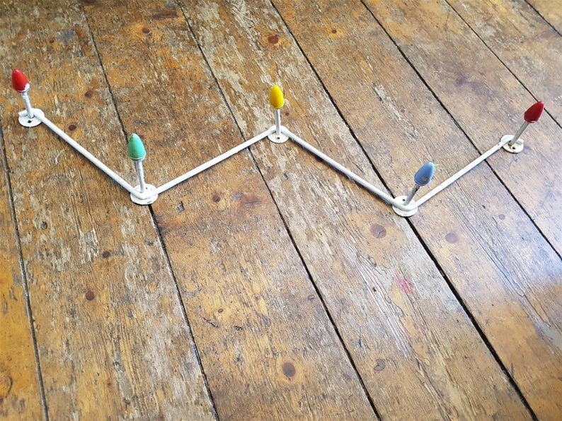 coat rack that looks like those opaque colored christmas lights. $49  https://www.etsy.com/listing/535783400/vintage-wall-coat-or-hat-rack-modernist?ref=user_profile