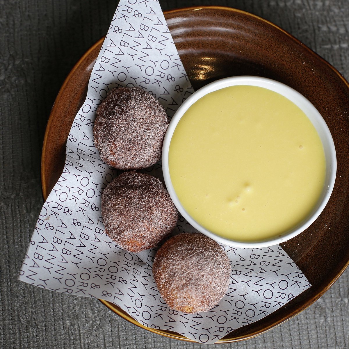 Sugared doughnuts with passionfruit curd... now available on our takeaway menu! Visit our website to learn more.  ✨