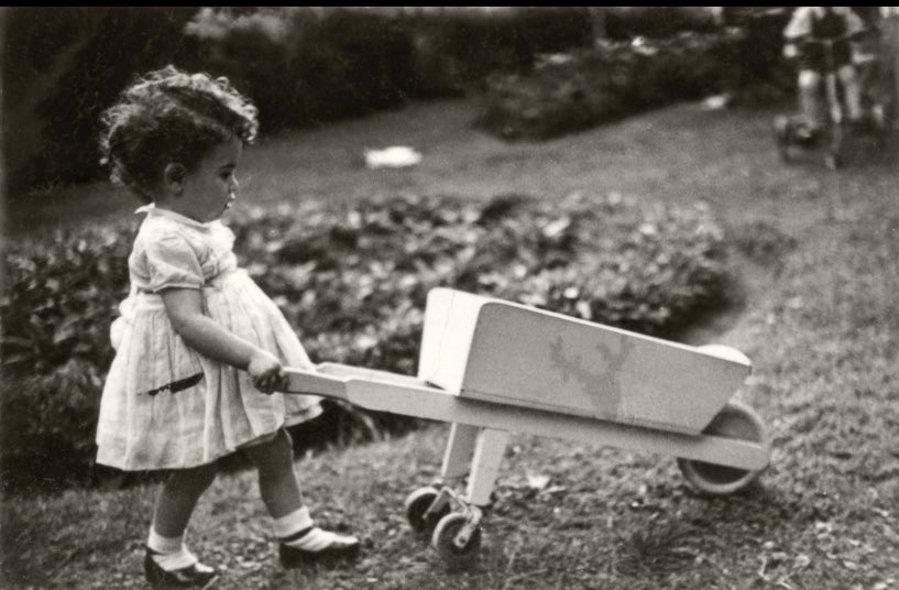 I love this photo of my mom as a little kid because she looks so ABSORBED in what she’s doing. She’s *in the moment* with that wheelbarrow, experiencing what some guy later in the century will call a state of flow