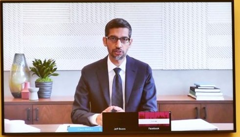 Pichai:- Dark wood desk adds gravitas, I trust people with wood desks- He owns books, so he's probably smart