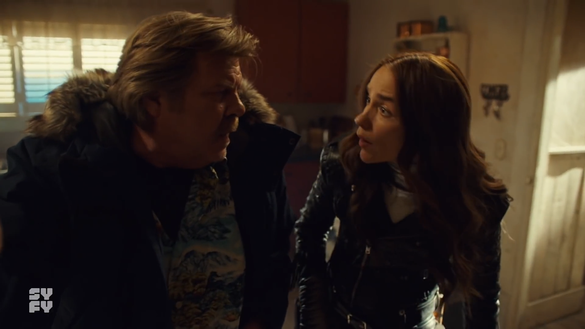 Now the table is hidden behind Nedley & Wynonna, but at this point, nothing is happening behind them yet. Wynonna ends up going back into the kitchen to find that First Aid kit that they have... not. The shotgun is still there.