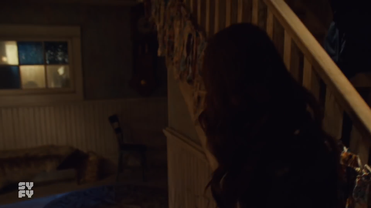 As the lighting changes (another complexity that had to be cued perfectly... likely with Wynonna finishing her sentence), Nedley is halfway up the stairs to where a package of Maxipads is waiting. He is safely out of sight. Varun follows the cameraperson around Wynonna.