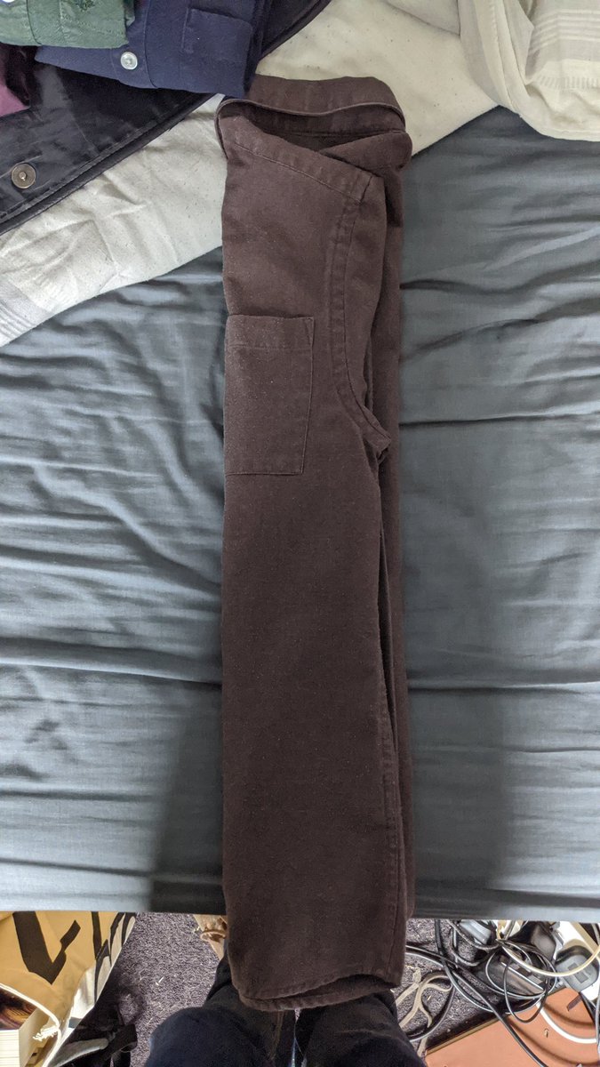 Step five: holding the shirt and sleeves at the shoulder and hem, fold into thirds