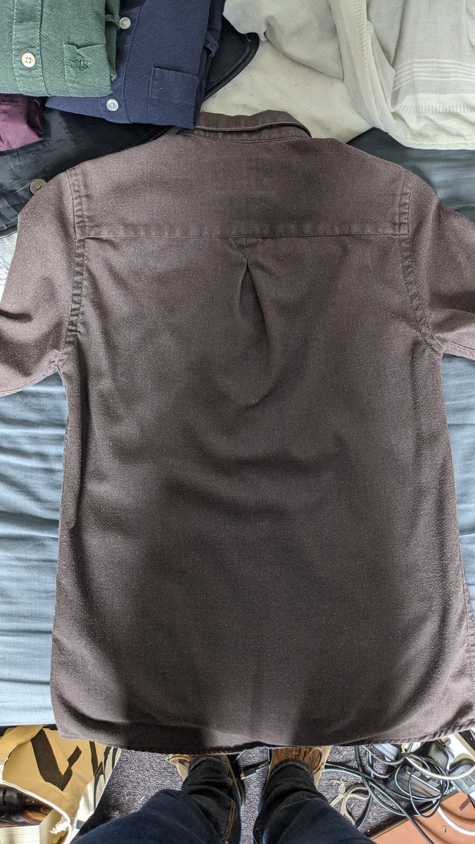 Step one: button ALL the buttonsStep two: find a flat surfaceStep three: lay the shirt out as flat as possible, buttons down