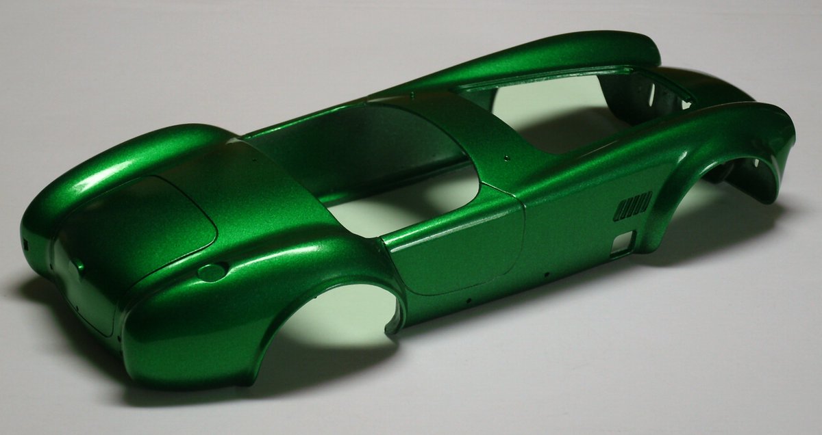HirakawaDavid's tweet photo. Today's is a Shelby Cobra driven by Sam Feinstein. The bodywork is painted Metallic green over black. The decals were really hard to get on right. I still have nightmares about that back wheel arch. #HirakawaStudios #Revell #Shelby #Cobra #SamFeinstein #Scalemodel. https://t.co/ybZZiOLSV8